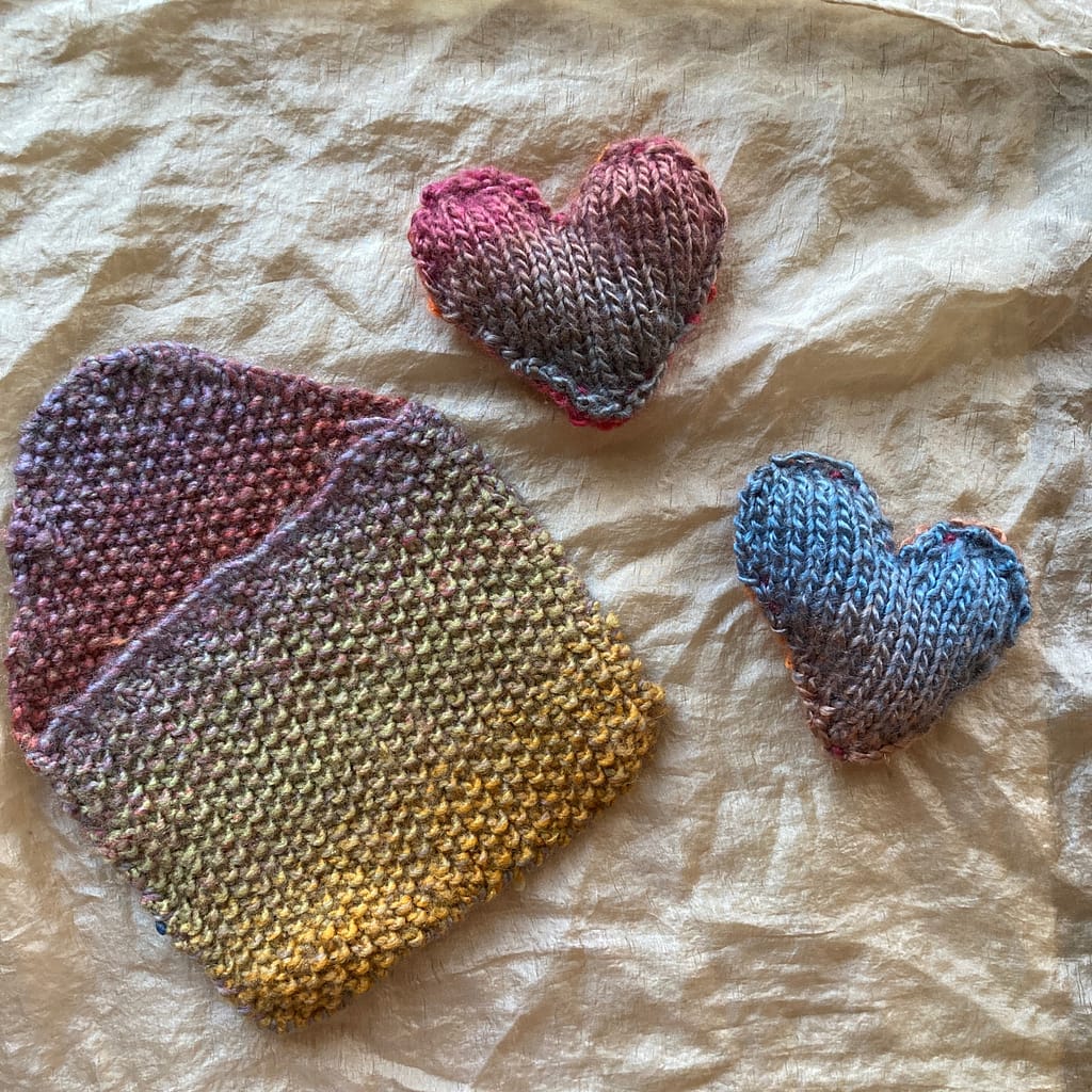 two knitted hearts and knitted envelope